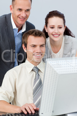 Business team working together with a computer