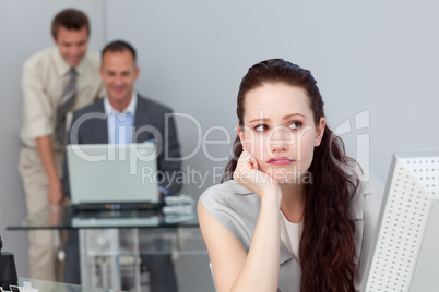 Thoughtful businesswoman using a computer in a company