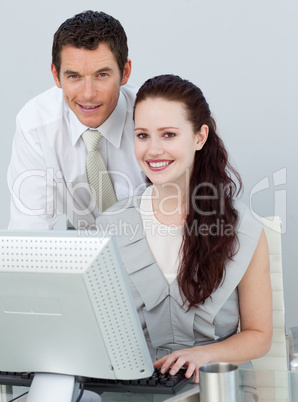 Businessman and businesswoman using a computer