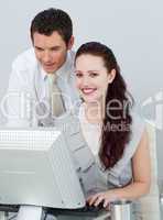 Businesswoman using a computer with her colleague