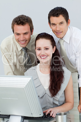 Smiling business people using a computer