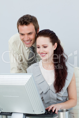 Attractive business people using a computer