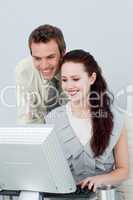 Attractive business people using a computer