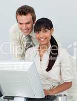 Attractive business colleagues using a laptop