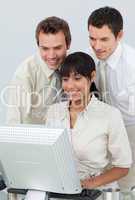 Businessmen and ethnic businesswoman working with a computer