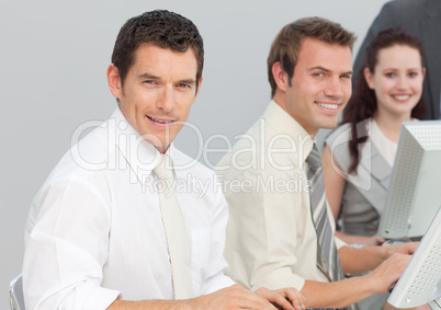 Business people using computers in an office