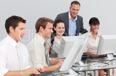 Multi-ethnic business people and manager working with computers