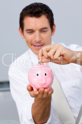 Businessman saving money in a piggybank