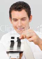 Attractive businessman consulting a card holder