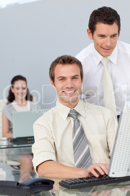 Businessmen working together with a computer