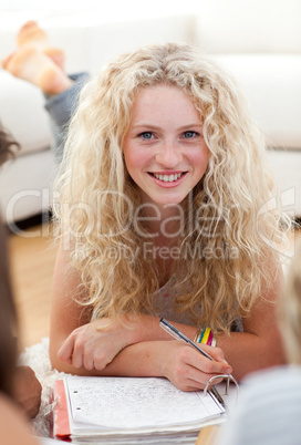 Beautiful teenager studying on the floor