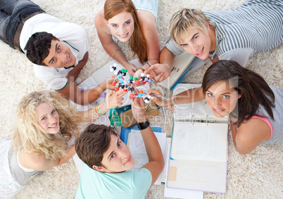 High angle of teenagers studying Science on the floor