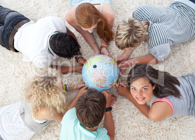 Group of friends on the floor examining a terrestrial world