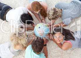 Group of friends on the floor examining a terrestrial world