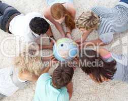 Group of teenagers on the floor examining a terrestrial world