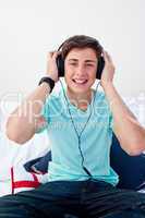 A teenage guy listening to the music in his bedroom