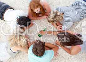 Group of teenagers playing with a bottle on the floor