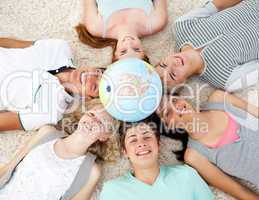 Teenagers on the floor with a terrestrial globe in the center