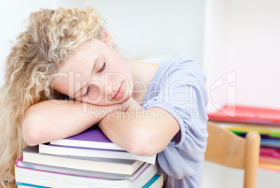 Tired teeenager sleeping in a library