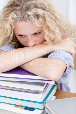 Tired teeenager sleeping on books