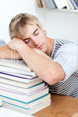 Tired teeenager sleeping in a library