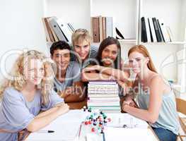 Smiling teenagers studying Science in a library