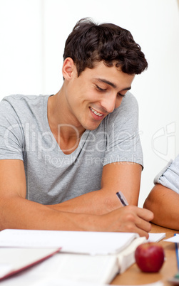 Portrait of a teen guy studying in the library