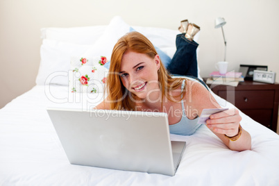 Teen girl using a laptop and shopping online