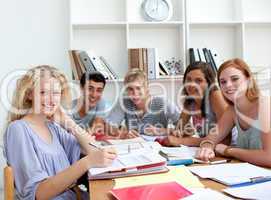 Teenagers doing homework in the library