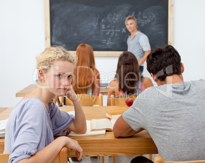 Teenagers studying together in a class