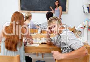 Teenagers studying together in a class