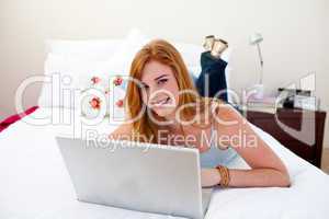 Smiling girl using a laptop