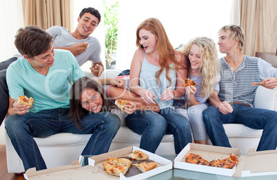 Adolescents eating pizza at home