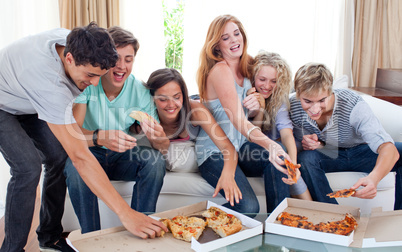 Friends eating pizza at home