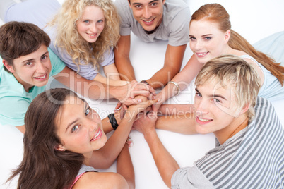Teens playing on the floor hands games