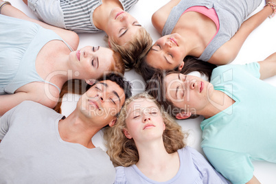 Teens sleeping on floor with heads together