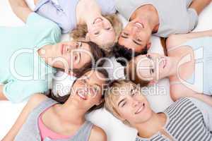Friends lying on floor with heads together