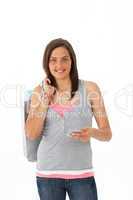 Beautiful teenager withholding shopping bags and a credit card