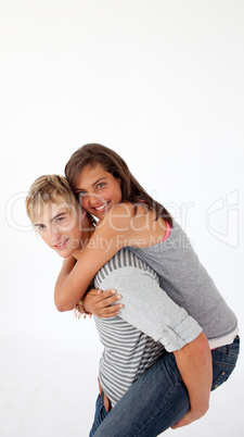 Young boy giving his girlfriend piggyback ride