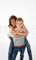 Teen guy giving a friend piggyback ride