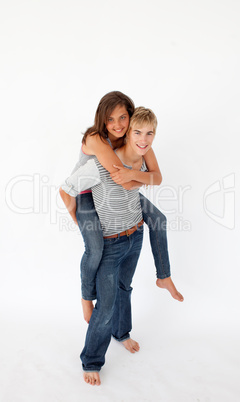 Young boy giving his girlfriend piggyback ride