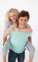 Teen guy giving a friend piggyback ride