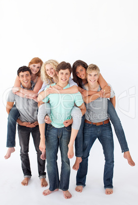 Teenagers giving their friends piggyback rides