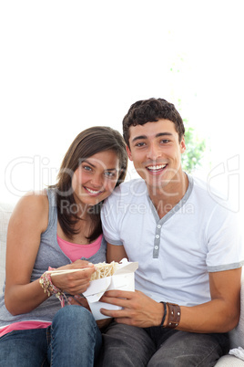 Couple of teenagers eating pasta with copy-space