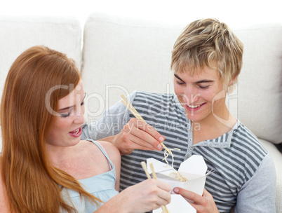 Couple of teenagers eating pasta