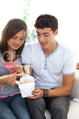 Couple of teenagers eating pasta