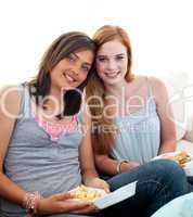 Young girls eating burgers and fries