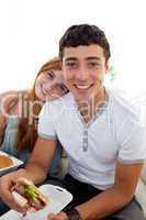 Teenagers eating burgers and fries