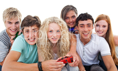 Excited teenagers playing video games in the living-room