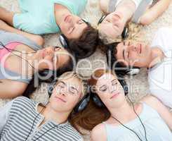 High angle of teenagers listening to music